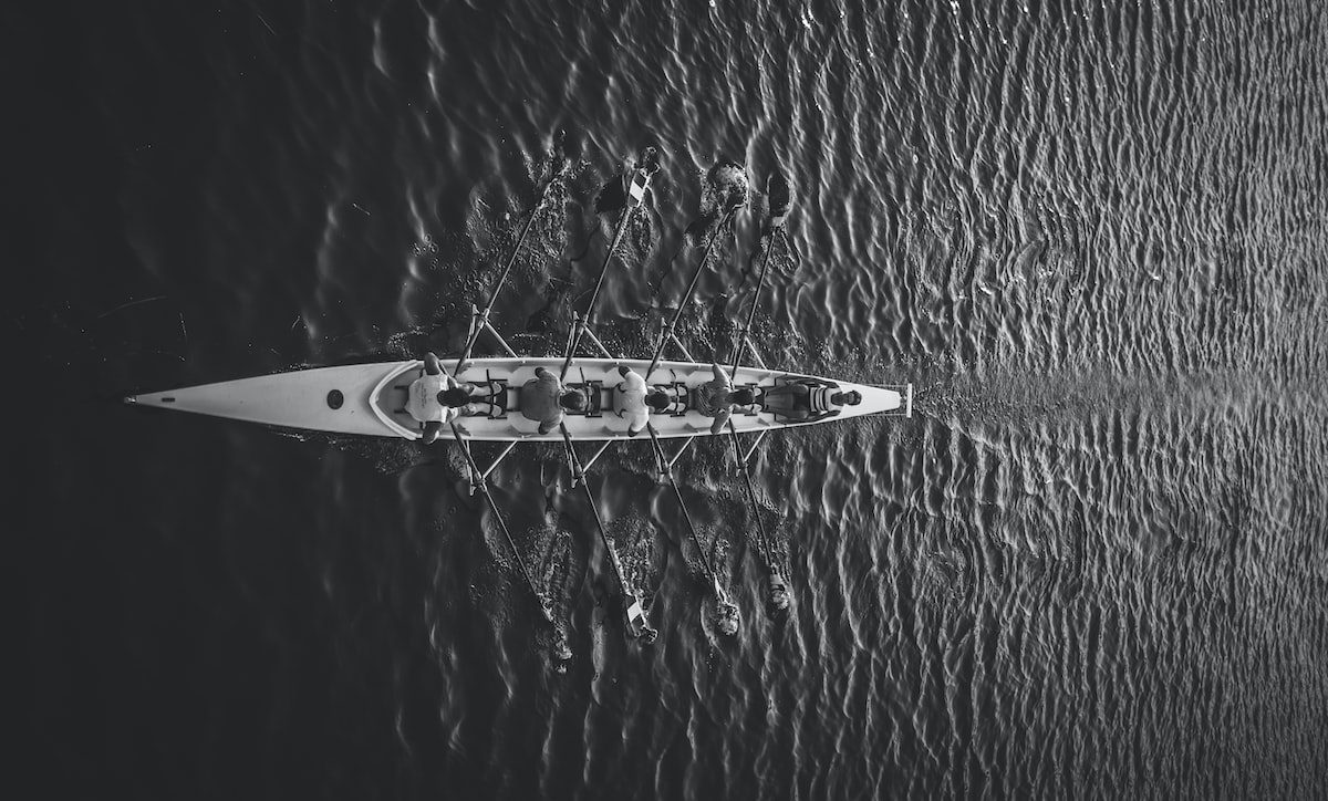 people riding boat on body of water